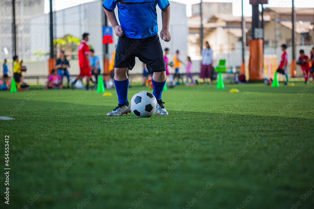 Children playing control soccer ball tactics on grass field with for training Children playing control soccer ball tactics on grass field with for training