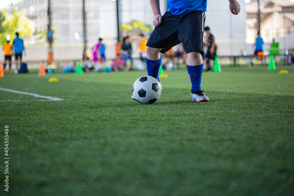Children playing control soccer ball tactics on grass field with for training Children playing control soccer ball tactics on grass field with for training