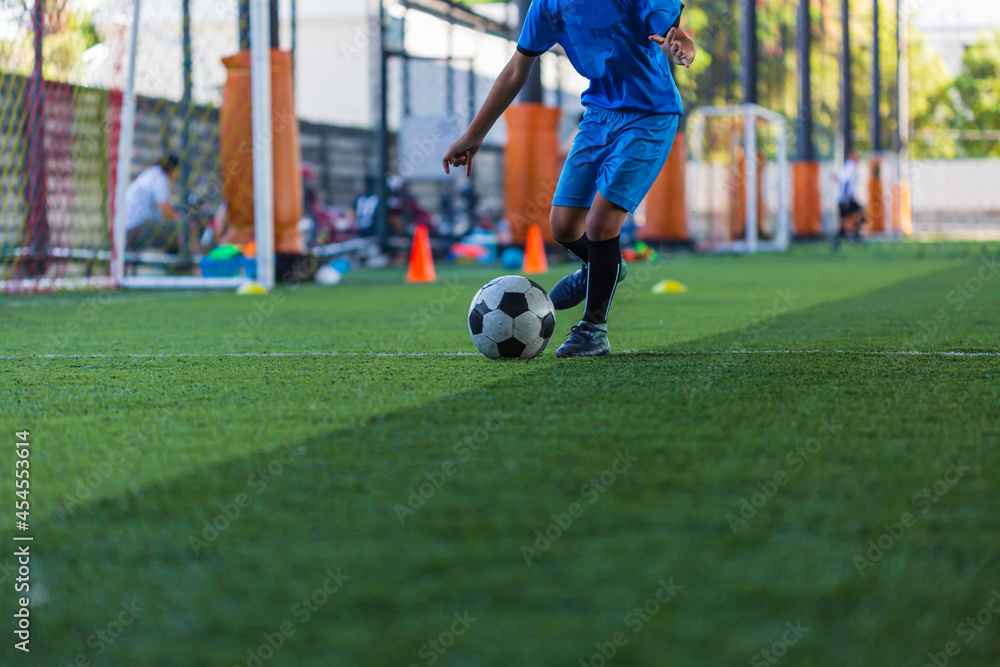 Children playing control soccer ball tactics on grass field with for training Children playing control soccer ball tactics on grass field with for training