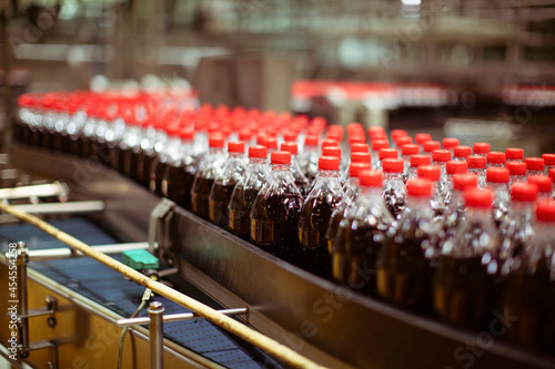 Beverage factory interior. Conveyor flowing with bottles for carbonated water.