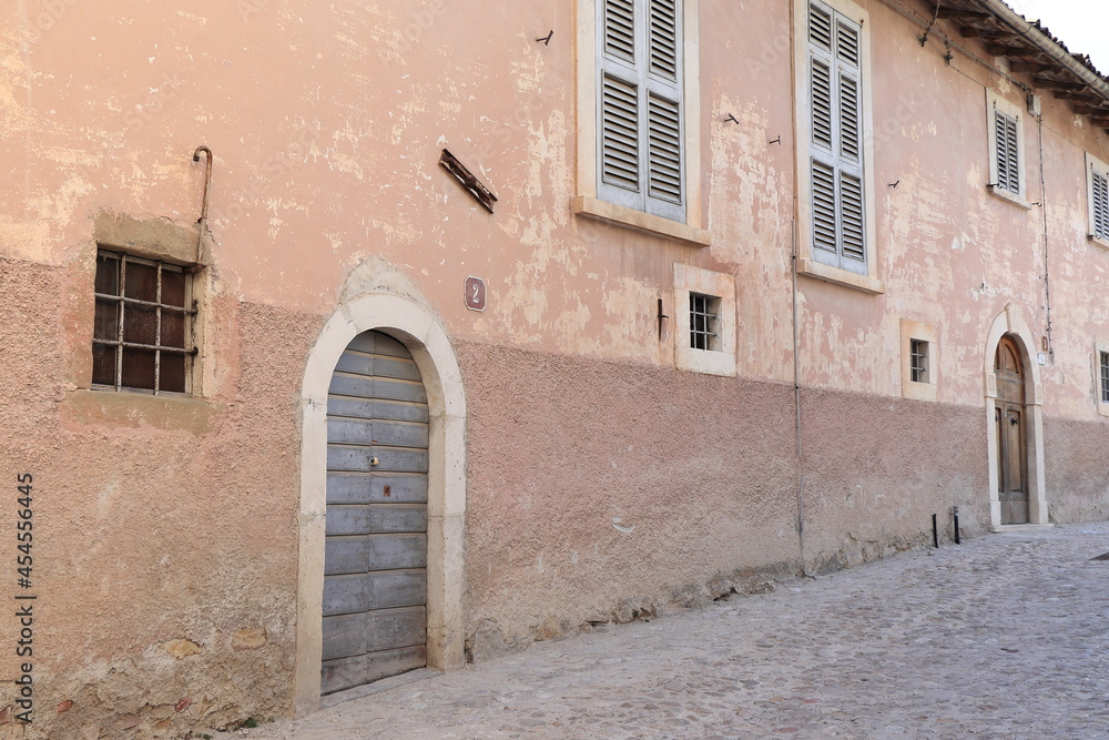 Rural Village Street View with Pink Historic House Facades in Central Italy