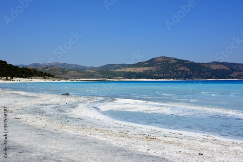 lake salda in Turkey with white sand and turquoise water with mountain and blue sky background  turkish maldives