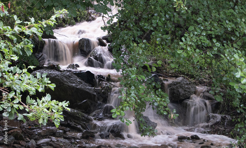 Magnifica cascada en movimiento rodeada de naturaleza. photo