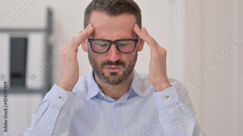 Portrait of Middle Aged Man having Headache 