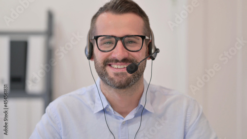 Portrait of Middle Aged Man with Headset Smiling at the Camera  © stockbakers