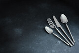 Cutlery on dark textured background. Table setting