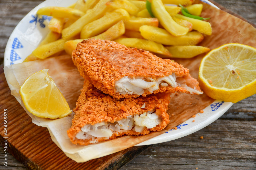 Fish and Chips.Close up of crispy breaded deep fried alaska pollock fillets with breadcrumbs served with remoulade sauce french fries and Fish and Chips.Close up of crispy breaded deep fried alaska pollock fillets with breadcrumbs served with remoulade sauce french fries and
