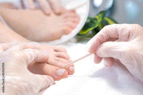 therapeutic pedicure with a stick for nails.