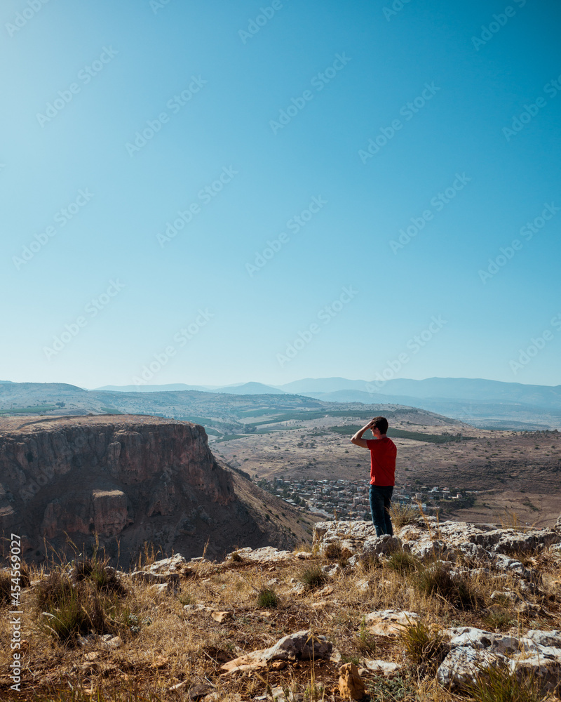 Man standing on the top of Mount Arbel in Israel
