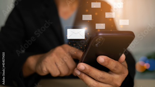 businessman sending marketing email icon with smartphones. Technology and email notification concept.cvbn bvcxz