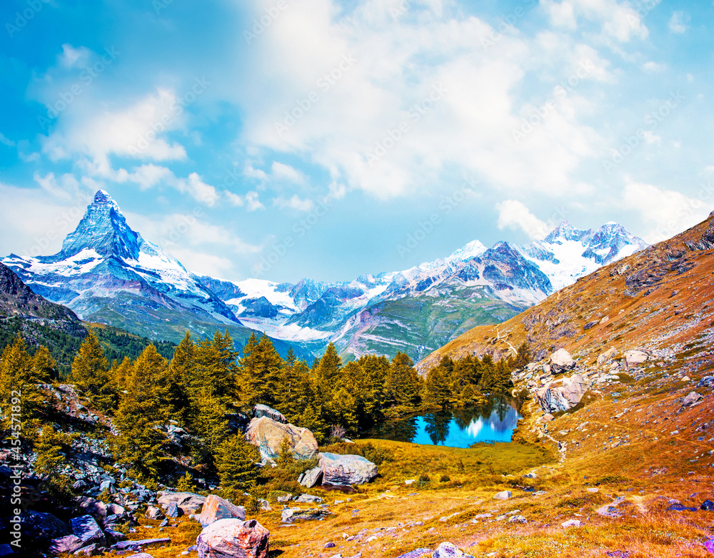 Magical beautiful autumn landscape with fir trees near lake on background Matterhorn in the Swiss Alps, near Zermatt, Switzerland. Amazing places. (Meditation, antistress - concept).