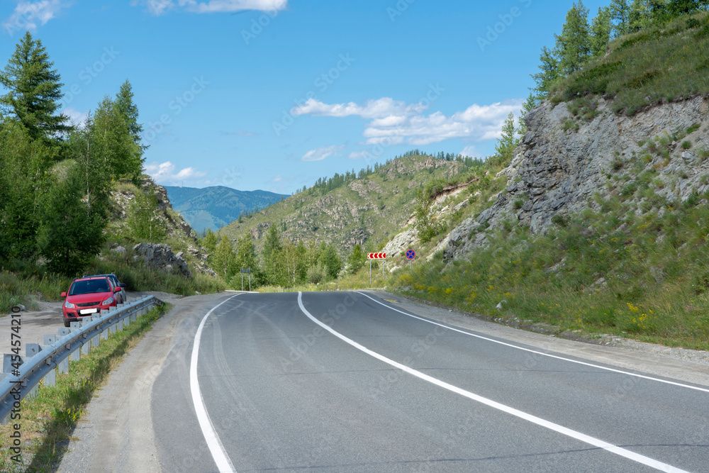 asphalt highway between rocks on a mountain pass. Russia, mountain Altai asphalt highway between rocks on a mountain pass. Russia, mountain Altai