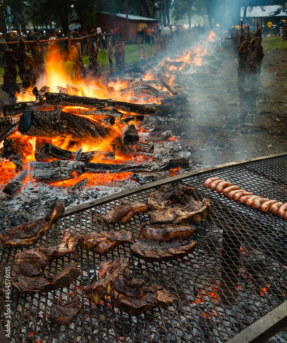 Asadores en la fiesta del asado en Cholila, Chubut, Patagonia con cordero, chivito y costillares vacunos photo