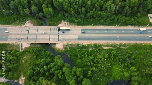Wallpaper Mural Aerial view of trucks and cars driving fast along the suburban highway. Transportation of goods as a business in the modern world. The concept of transport links between settlements, cities. UHD 4K. Torontodigital.ca