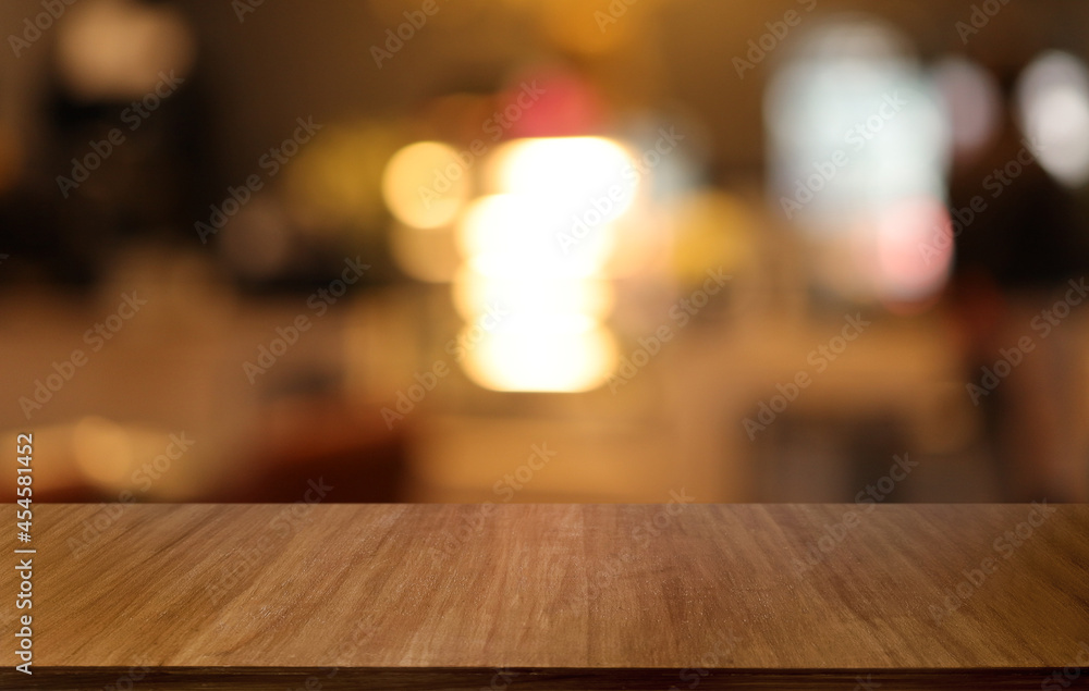 Empty wooden table in front of abstract blurred background of coffee shop . can be used for display or montage your products.Mock up for display of product Empty wooden table in front of abstract blurred background of coffee shop . can be used for display or montage your products.Mock up for display of product