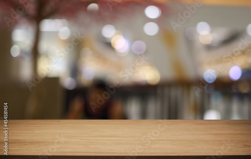 Empty wooden table in front of abstract blurred background of coffee shop . can be used for display or montage your products.Mock up for display of product