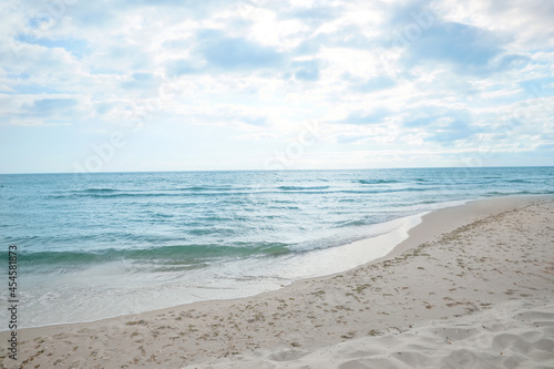 Sea waves rolling onto sandy tropical beach