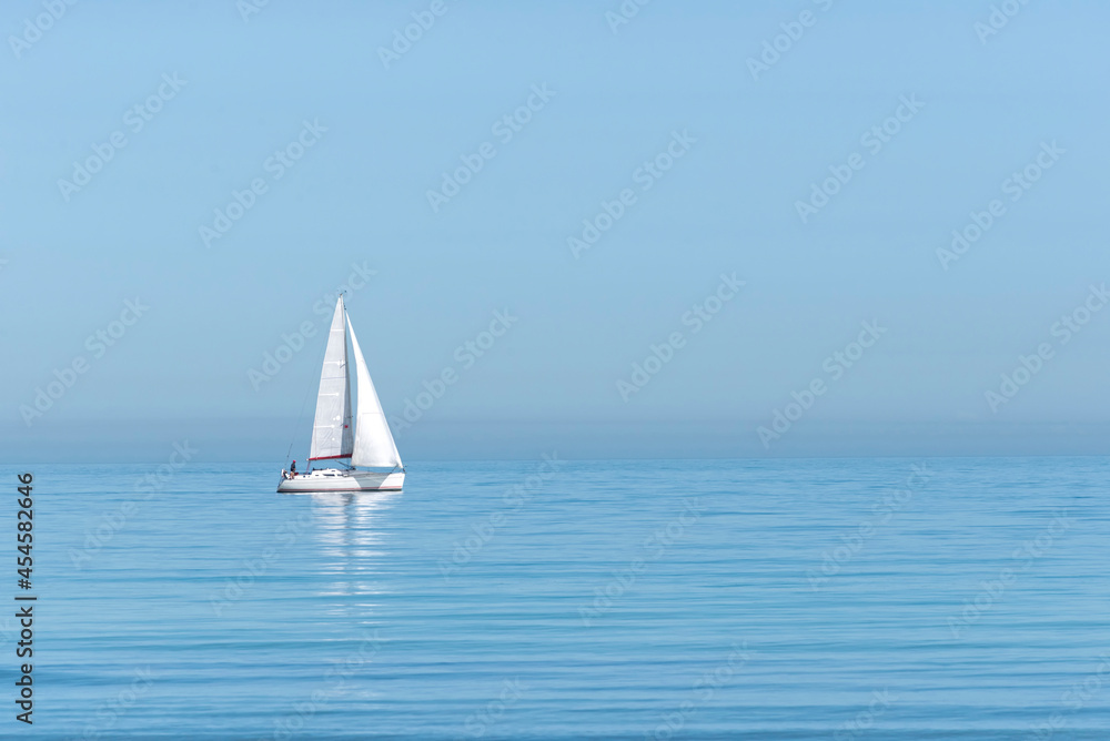 Sailing boat on sea against clear sky