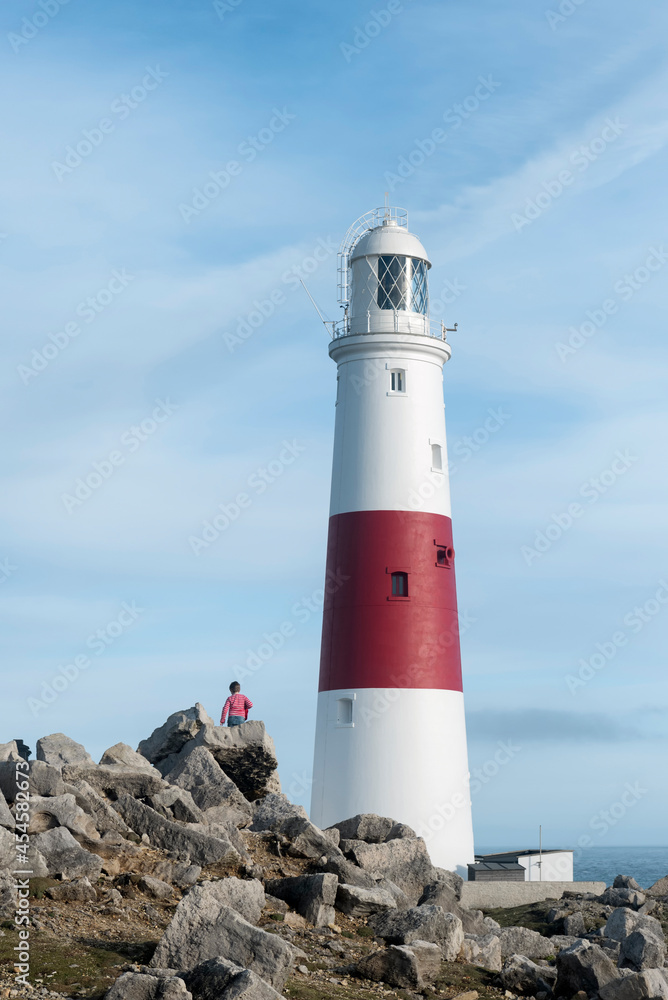 Boy walking around a lighthouse