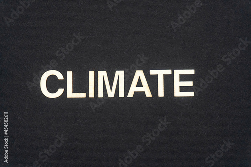 CLIMATE word written on dark paper background. CLIMATE text for your concepts