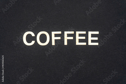 COFFEE word written on dark paper background. COFFEE text for your concepts