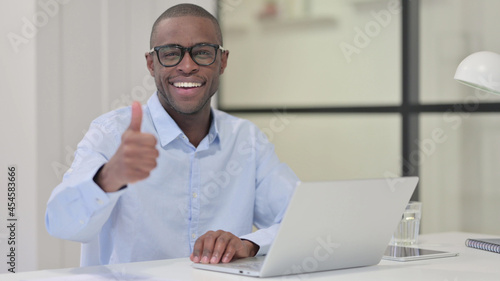 Thumbs Up by African Man with Laptop at Work 