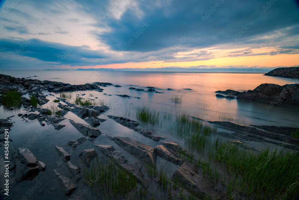 Wonderful sunset at St-Jean-Port-Joli's coasts, at low tide, on the shore of St-Lawrence river.