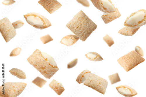 Sweet crispy corn pads flying on white background