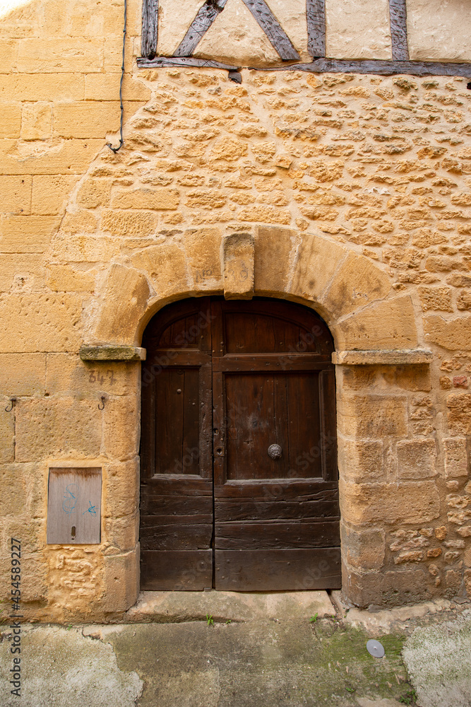 Old wooden door in Europe.  Limestone house.