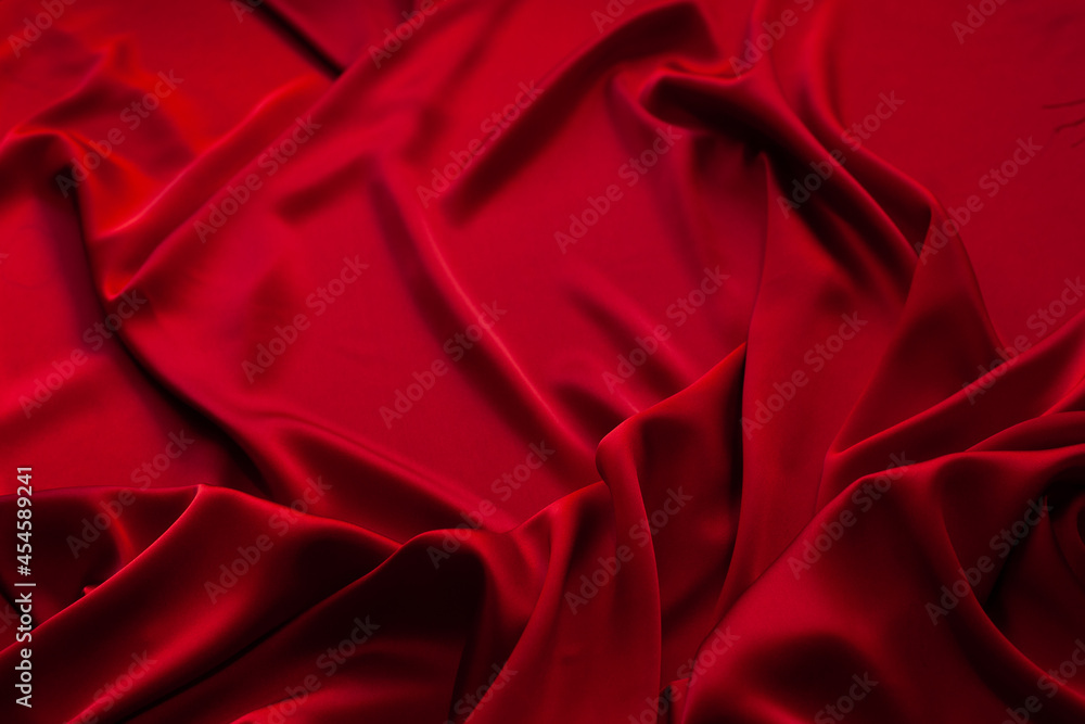Red fabric texture background. Silk satin folds Red fabric texture background. Silk satin folds
