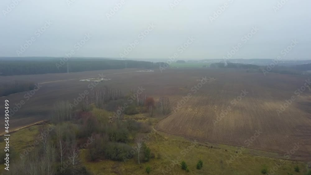 Top view of autumn agricultural fields in fog. Fog and mist covering autumn agricultural fields near a big city and lake. Countryside concept. Top view of autumn agricultural fields in fog. Fog and mist covering autumn agricultural fields near a big city and lake. Countryside concept.