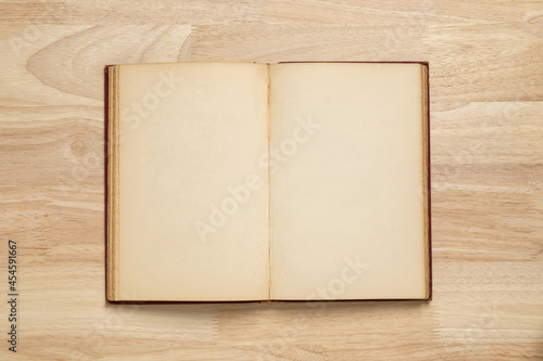open old book on wooden table for mockup blank template