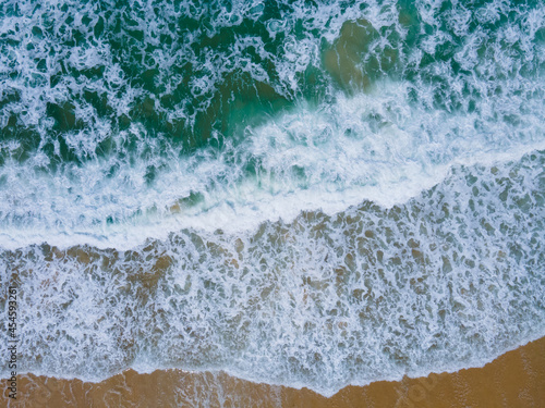 (Top view) Aerial view drone over beach sea. Beautiful sea waves. Beach sand and amazing sea. Summer sunset seascape. Phuket Thailand Beach. Water texture. Top view of the fantastic natural sunsets