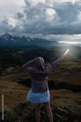 Woman with flashlight in su...