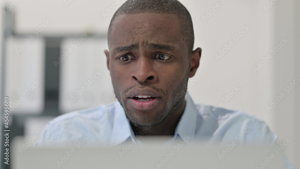 Close Up of African Man having Loss while using Laptop Close Up of African Man having Loss while using Laptop