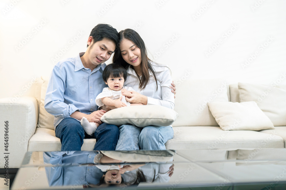 Asian Parents and a kid child playing at home. Family concept.