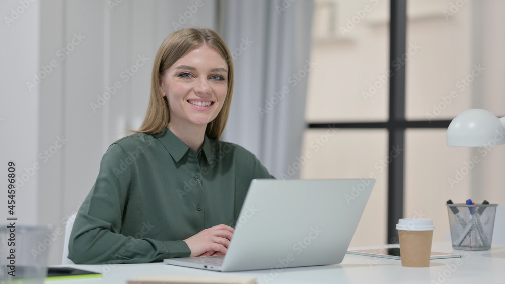Young Woman with Laptop Smiling at Camera Young Woman with Laptop Smiling at Camera