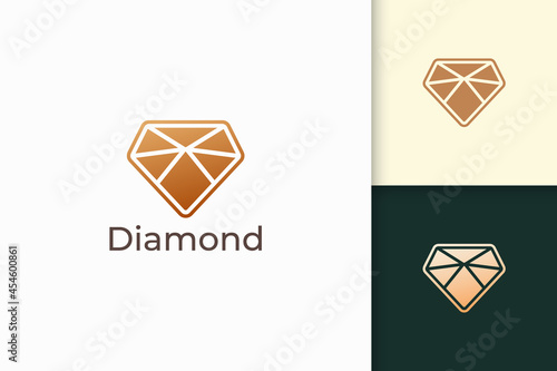 Luxury gem or jewel logo in diamond shape with gold color