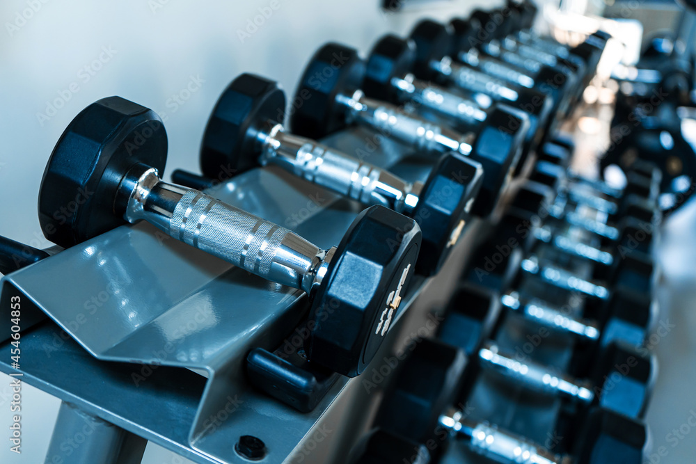 Rack with dumbbells of different weights close up Rack with dumbbells of different weights close up