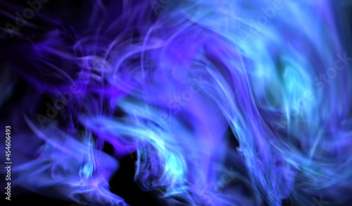 Abstract and mystical blue smoke or light energy flow on black background. Ethereal effect. Can be used for meditation,heaven, vortex, magic spells, fantasy.