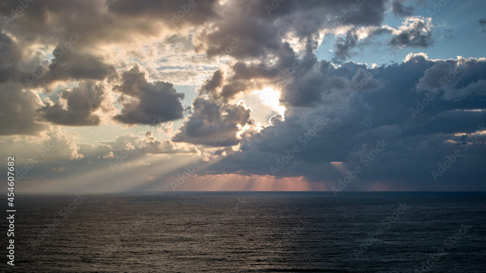 sunset over the sea, clouds, sun rays