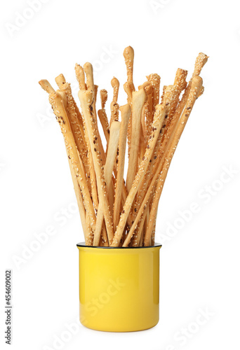 Delicious grissini sticks in cup on white background