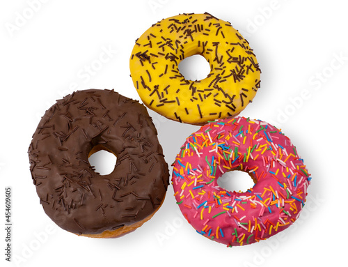 Three donuts covered with chocolate and sugar icing and chocolate chips isolated on a white background.Fresh bright pastries on a white background.