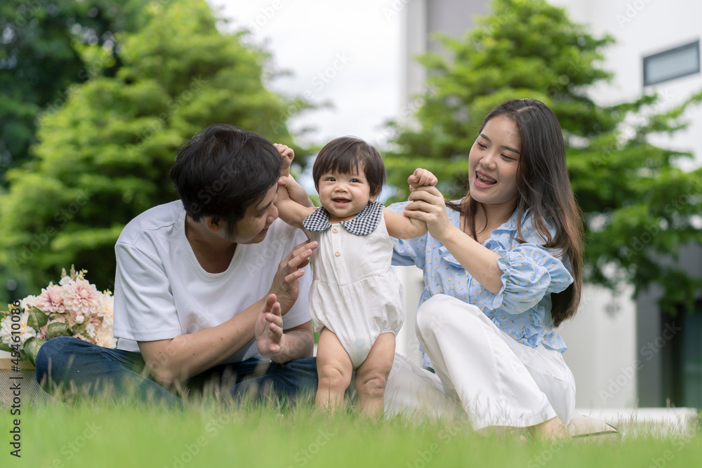 Asian Parents and a kid child playing in the garden at home. Family concept. Asian Parents and a kid child playing in the garden at home. Family concept.