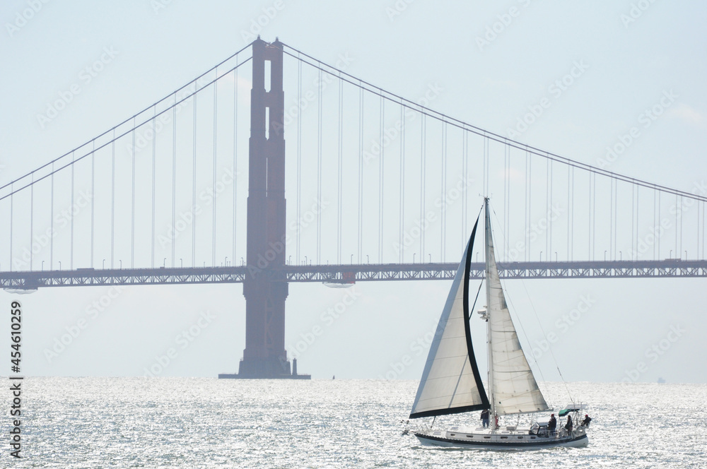 Sailboat crossing the San Francisco Bay, with the Golden Gate Bridge in the background Sailboat crossing the San Francisco Bay, with the Golden Gate Bridge in the background