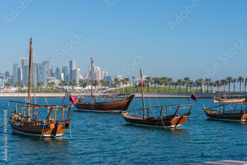 Traditional Arabic Dhow boats with the view of modern buildings in Doha, Qatar