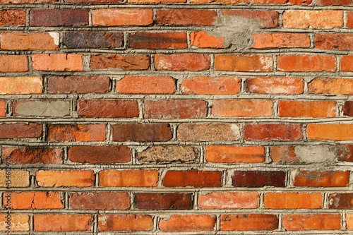 Parede de tijolos vermelhos e cimento aparente photo