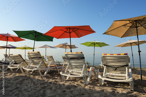 Many colorful beach umbrellas and sunbeds at resort