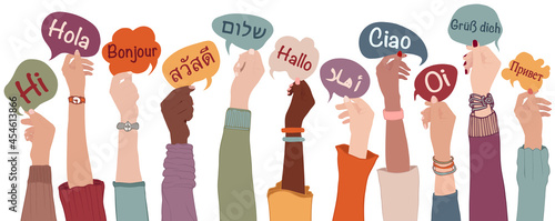Raised arms and hands of multiethnic people from different nation country and continents holding speech bubbles with text -hallo- in various international languages.Communication.Equality photo