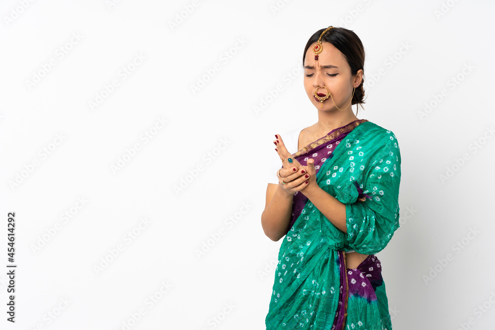 Young indian woman isolated on white background suffering from pain in hands Young indian woman isolated on white background suffering from pain in hands